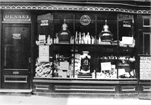 The Pharmacy, at 13 Market Place, North Walsham, was run by E.J.Denney from 1869 - 1906 when it became 