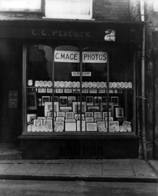 Photograph. Charles Mace, Photographer 2 Market Place, North Walsham., previously Miss C.L. Peacock, Tobacconist & Walter Joseph, Peacock, Saddler late 20's & 30's (North Walsham Archive).