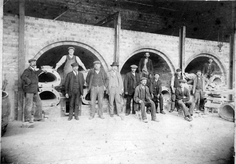 Photograph. North Walsham Gas Works, Mundesley Road. Reconstruction of the Retort House. John Dixon, Secretary and Manager in trilby. (North Walsham Archive).
