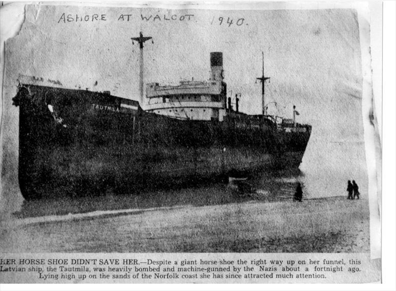 Photograph. Walcott Beach, 1940. The wreck of the Latvian ship, "Tautmila", beached after being heavily bombed and machine gunned by Nazis in World War Two (North Walsham Archive).