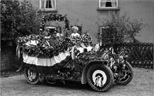 Decorated car ready for the Coronation Procession, 1911, Palmer's Yard, Vicarage St., North Walsham. Driver has Royal Norfolk Regt. cap badge.