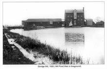 Ebridge Mill beyond its Mill Pond. Mill Pond Weir in left foreground