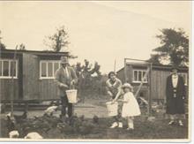 Land belonging to Aylsham House in the 1920's. Barbara Blewitt (now Thirwell) helps to feed the chickens.