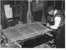 Mr L.W.Roper, Craftsman, at work on the World War Two Memorial