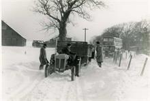 Tractor and Eastern Countries bus in snow at Hall Farm, Paston.