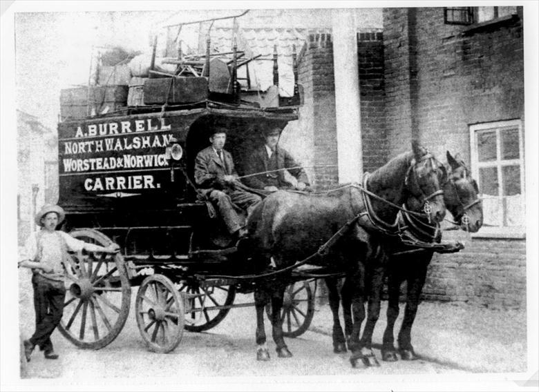 Photograph. Archibald Burrell (senior), driving his house removals wagon near Preference Place, Bacton Road, North Walsham. Photo Bob Burrell collection (North Walsham Archive).