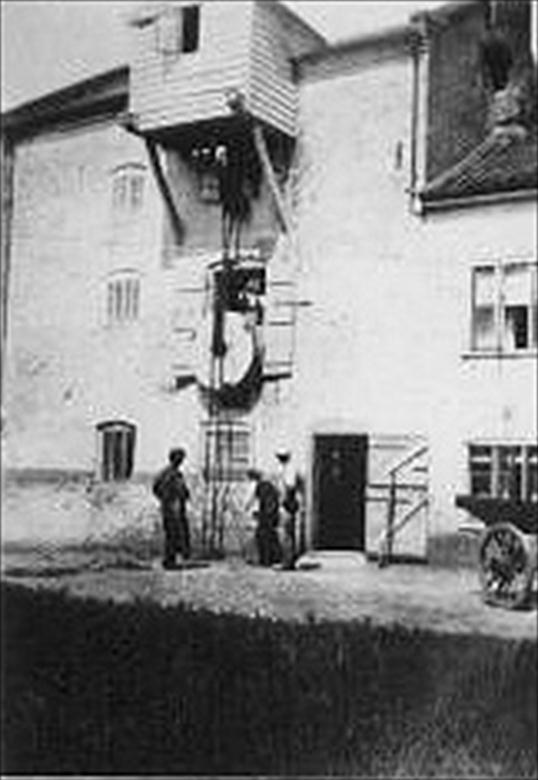 Photograph. Bacton Wood Mill receiving a new mill-stone. North Walsham-Dilham Canal. Ling collection (North Walsham Archive).