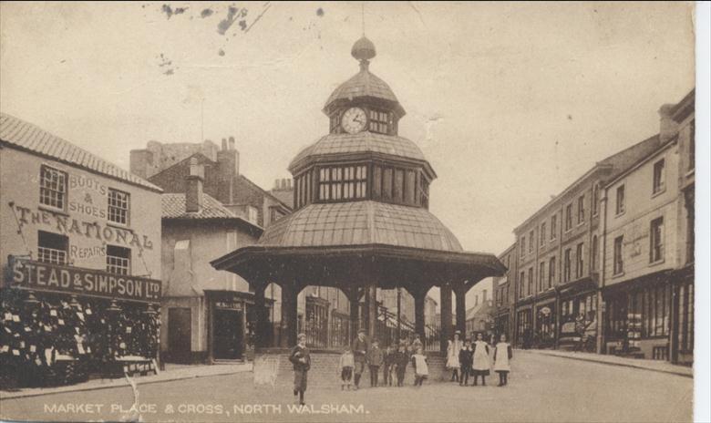 Photograph. Chidren by Market Cross, North Walsham. (North Walsham Archive).