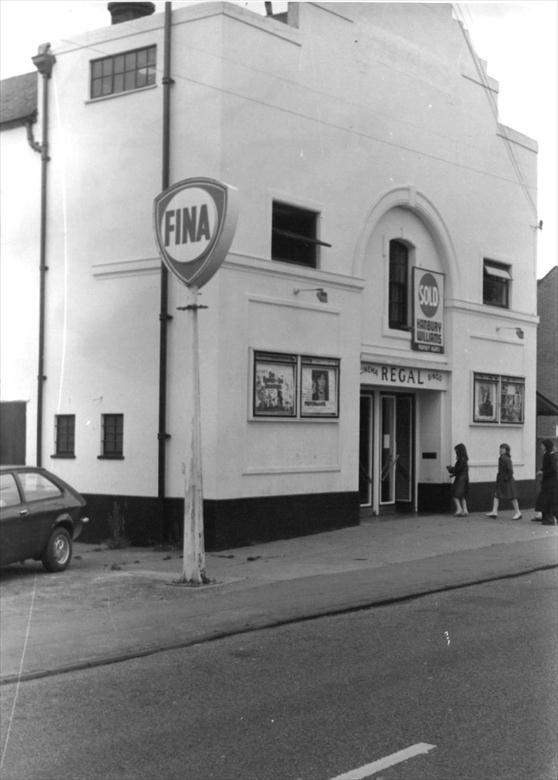 Photograph. Last days of the Regal Cinema, New Road, North Walsham. Whilst still open, there is a "Sold" sign above the door. (North Walsham Archive).