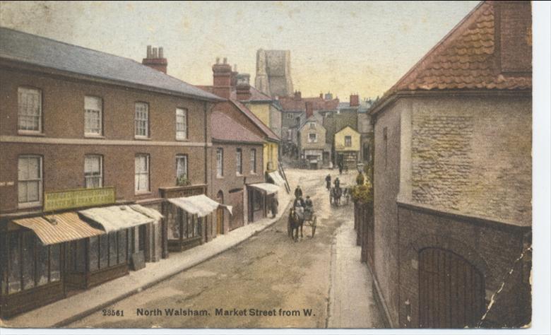Photograph. Market St., Nth. Walsham. The Norwich Co-operative Society opened in 1906, burned down in 1916, was rebuilt in 1921 and ceased trading in 1963. (North Walsham Archive).