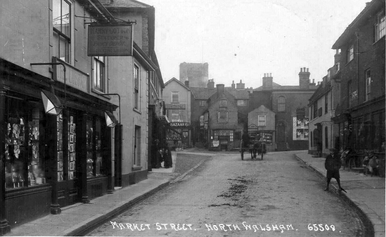 Photograph. Market Street looking east towards The Butchery. Harry Cotton's Stationery (and Library) shop existed but a few years before W.W.1. (North Walsham Archive).
