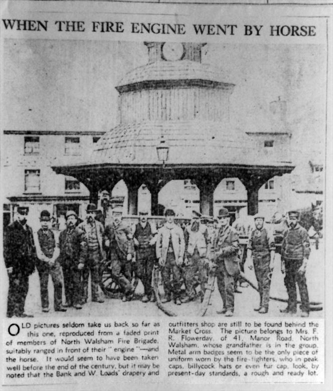 Photograph. -North Walsham's second fire engine with a volunteer crew before the Market Cross (North Walsham Archive).