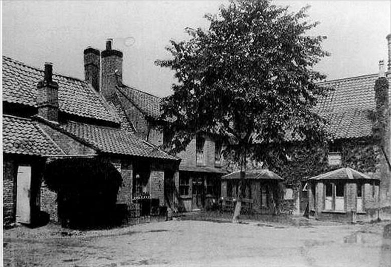 Photograph. Rear view of the Cross Keys Hotel taken from the Cross Keys Yard. The door to the Lounge Bar is on the far left. (North Walsham Archive).