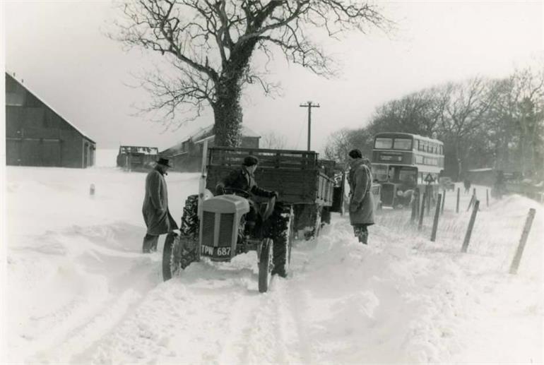 Photograph. Tractor and Eastern Countries bus in snow at Hall Farm, Paston. (North Walsham Archive).