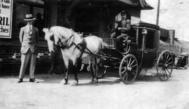 Photograph. William Royall, publican of the Trunch New Inn, collecting a client from the North Walsham "Main" Railway Station, Norwich Road. (North Walsham Archive).