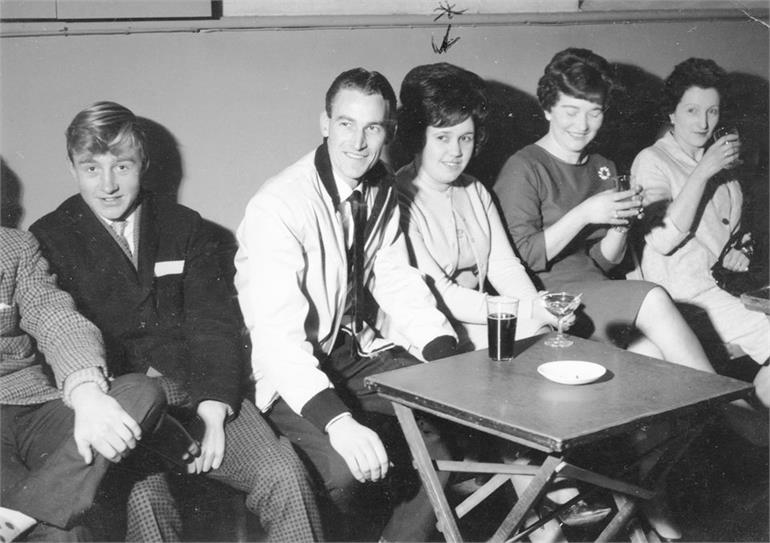 Photograph. The writing on the back reads - "First Fruehauf Christmas Party 1963. Madeline Fitzgerald won lighter." (North Walsham Archive).